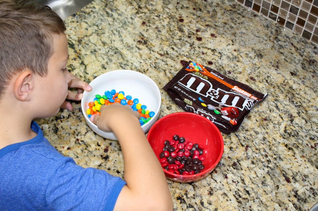 Picking out the brown and red M&Ms for the Winnie the Pooh Ice Cream Cake