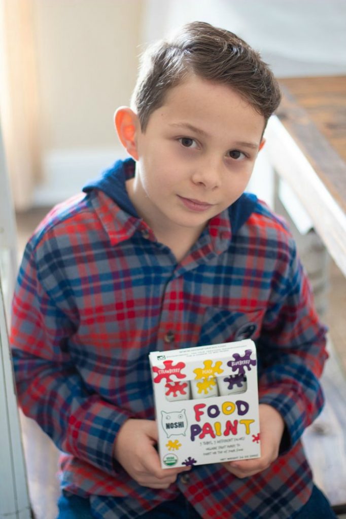 Child holding box of Noshi Food Paint