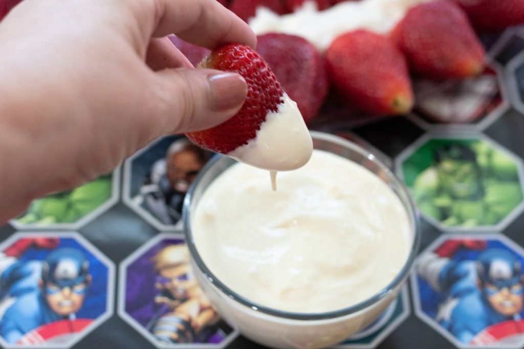 Dipping Strawberries from Captain America Fruit Tray in Fruit Dip