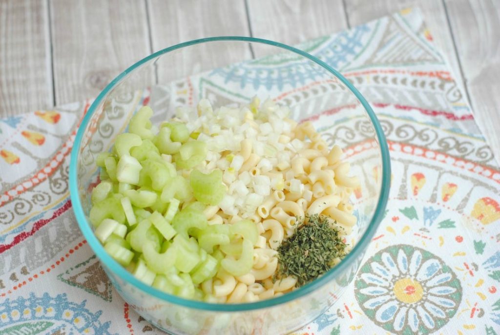 Chicken Salad ingredients in a glass bowl with pasta