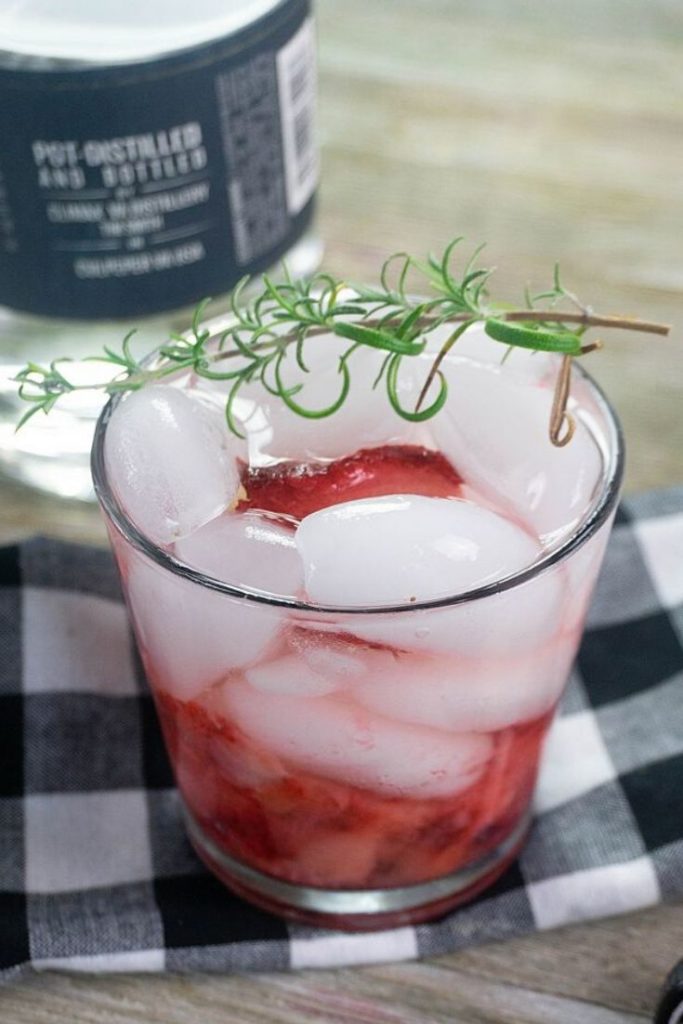 Strawberry Rosemary Moonshine with fresh strawberries and topped with rosemary 