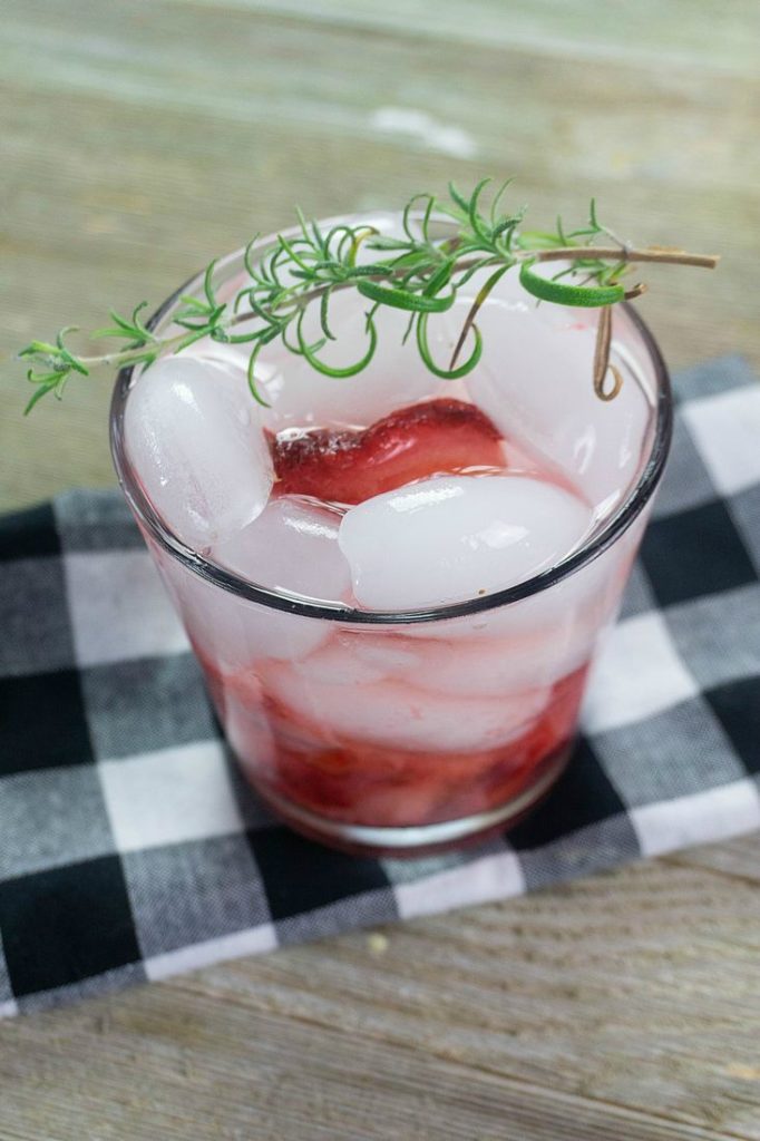 Strawberry Rosemary Moonshine made with smashed strawberries and moonshine 