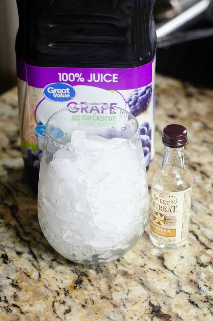 Photo of grape juice with a glass of ice and bottle of Sweet Retreat Vanilla Liqueur