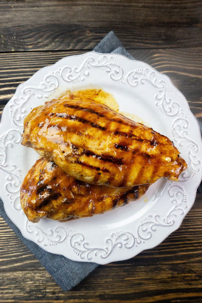 Skillet Barbecue Chicken Breast on a white plate with blue napkin