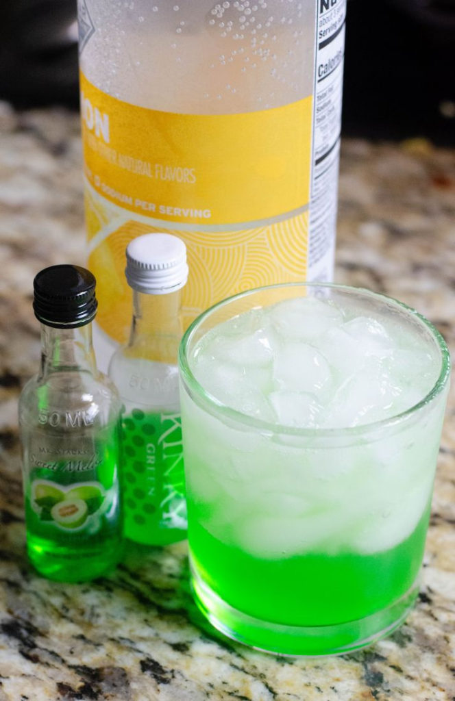 process image of glass and ice with green liquor
