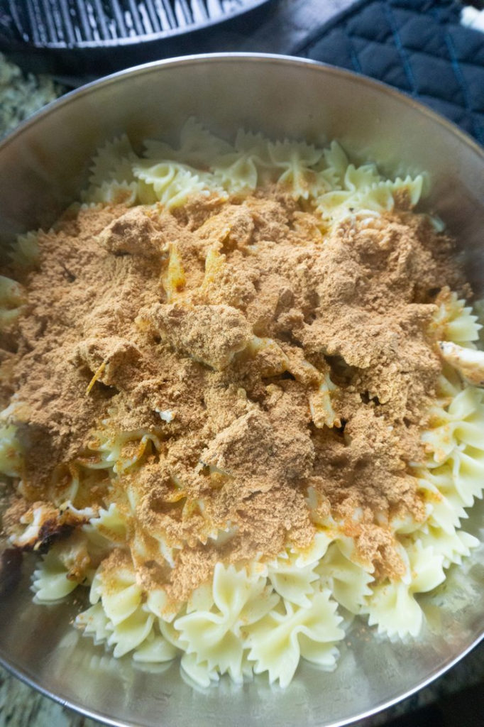 Bow-Tie Pasta, Chicken, and veggies with Taco Seasoning in mixing bowl