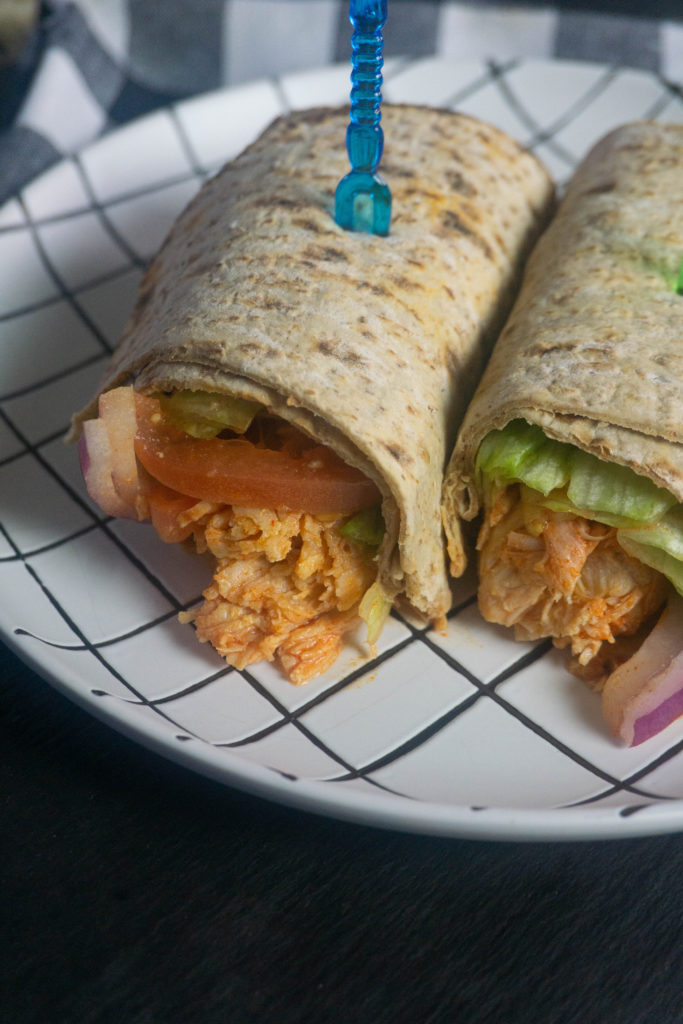 Instant Pot Buffalo Chicken Wraps on a black and white plate.