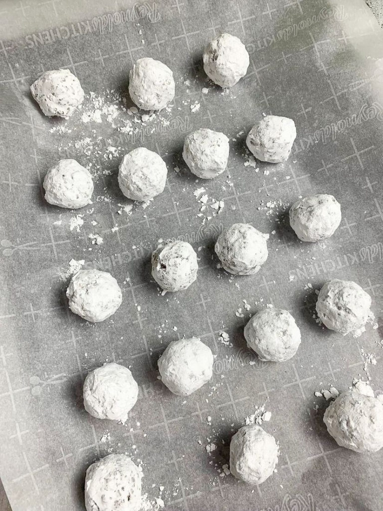 Bourbon Whiskey Balls on cookie sheet lined with parchment paper.